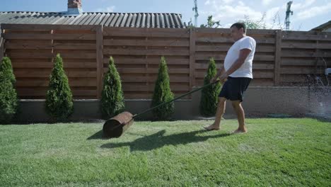 man laying sod grass in backyard garden for lawn installation and landscaping project, focused on home improvement and outdoor maintenance for a fresh, green lawn in a residential yard