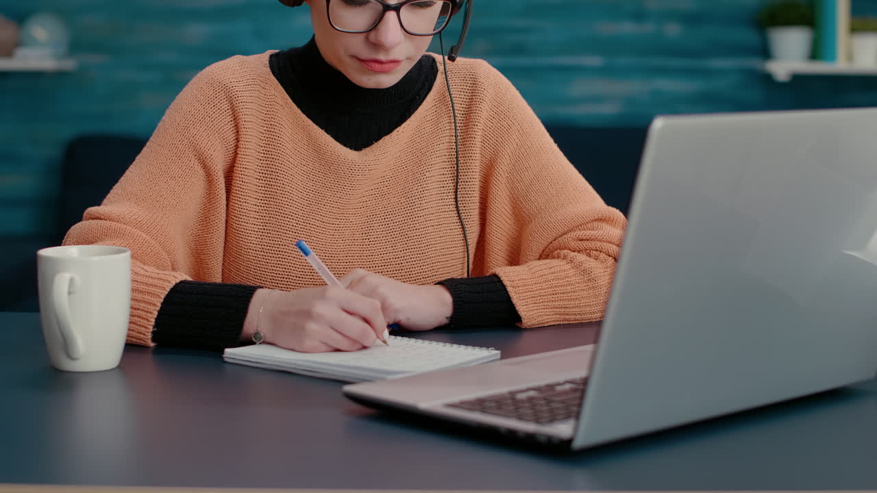 Young adult attending teleconference call on laptop
