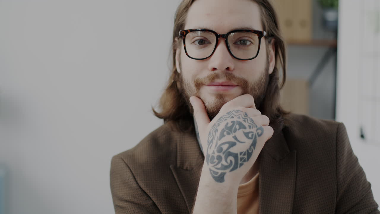 Portrait of a Man with a Hand Tattoo in an Office