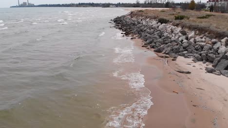 two-birds-on-a-beach-lake-in-the-Midwest-near-a-factory