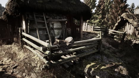 rustic farmhouse with thatched roof and wooden fence in natural landscape