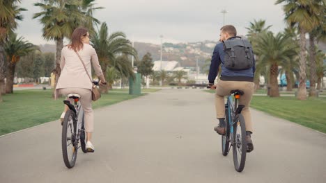 couple cycling in a park