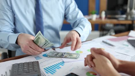 businessman counting dollar bill in front of woman in office 4k movie slow motion