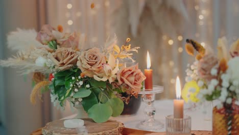 elegant table setting with beige roses greenery and candles glowing in warm ambient light