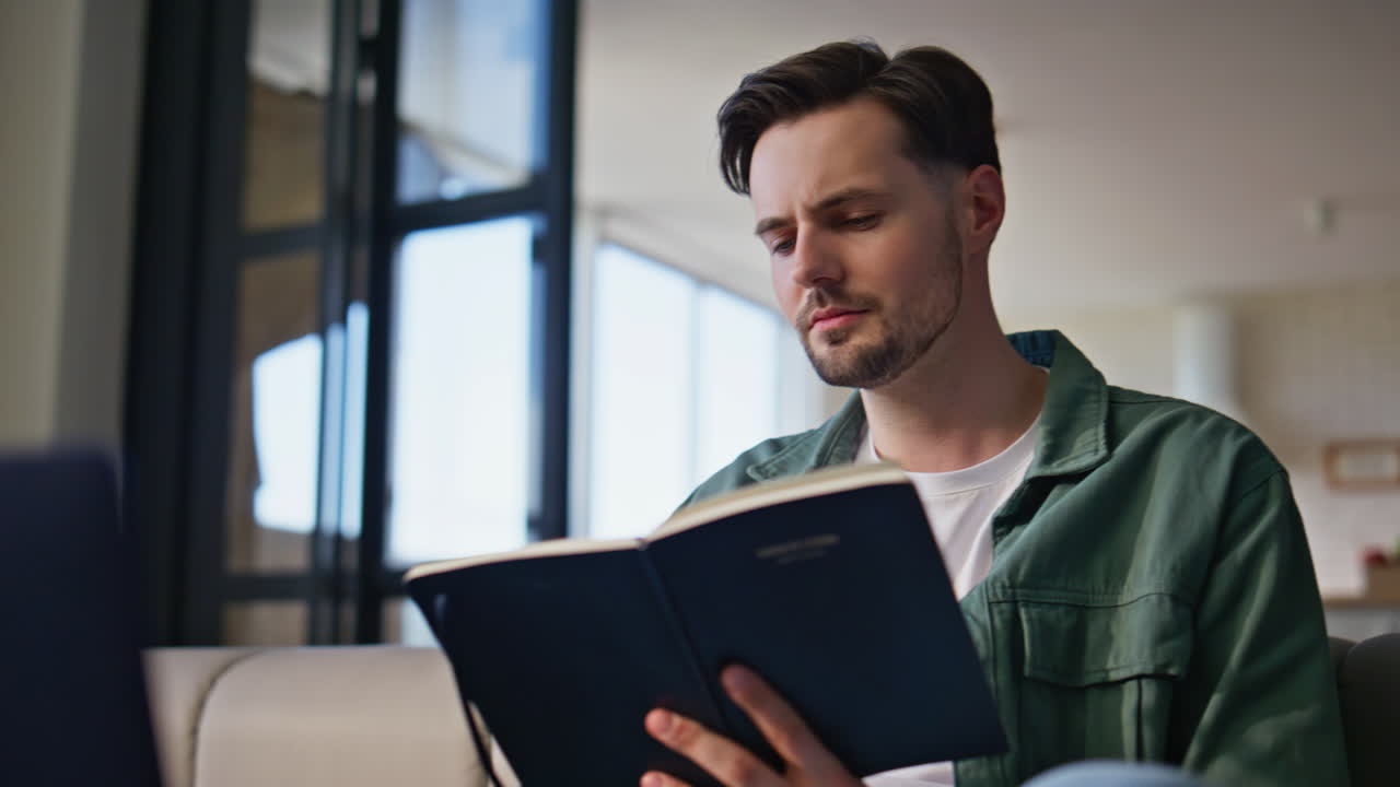 Online student writing homework at home closeup. Focused man looking laptop
