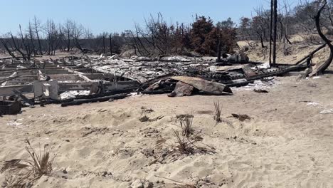 remains of building of after extreme wildfires in rhode, motion view