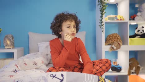 Confused-boy-muttering-to-himself-in-bed.