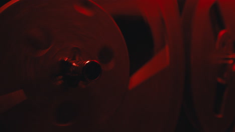 a close-up on a vintage tape recorder in a red blinking light