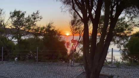 wide-and-close-view-of-camera-captures-a-breathtaking-view-of-a-massive-and-awe-inspiring-sunrise-over-the-Tagus-River-in-Santo-Amaro-of-Oeiras