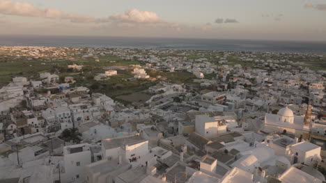 aerial view of a whitewashed village on a greek island at sunset