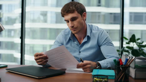 exhausted businessman taking documents reading unsatisfied information close up.