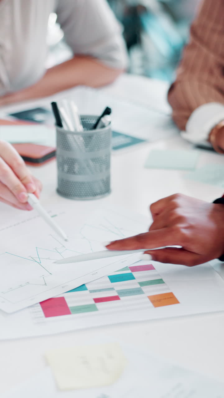 Business People Analyzing Data and Graphs on Documents in Office