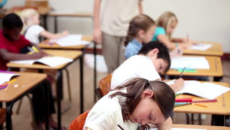 pupils writing on their notebooks