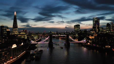 Aerial-View-of-London-over-the-River-Thames-including-Tower-Bridge,-Shard-and-the-Tower-of-London-at-twilight