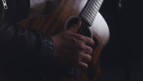 man plays guitar on stage 4k