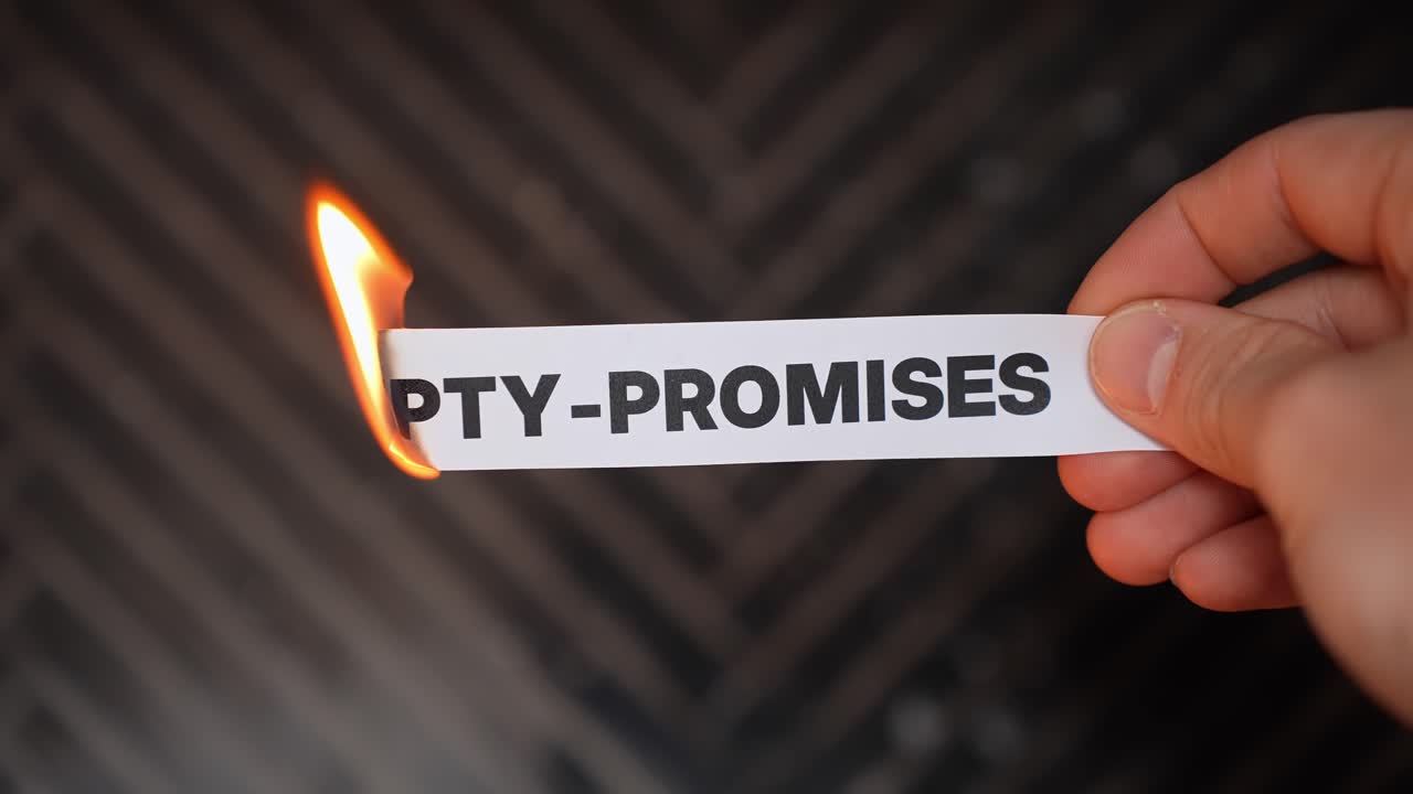 Close-up hand burns a paper label reading “EMPTY-PROMISES,” symbolizing betrayal, lies, and broken commitments. Dark background with copy space for business or relationship conflict themes