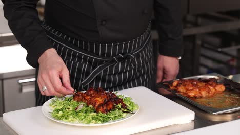 chef preparing grilled chicken skewers with salad