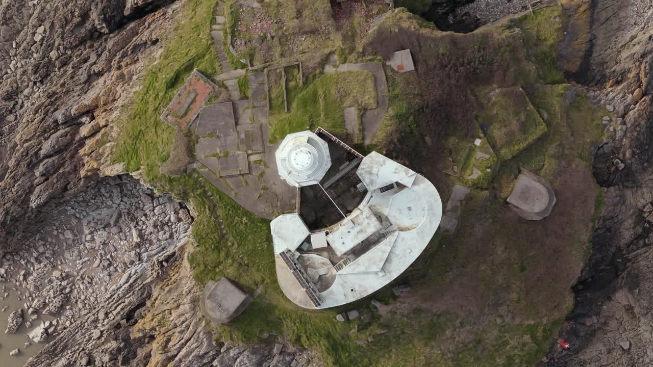 Top view of Mumbles Lighthouse during daytime in United Kingdom. Drone shot.