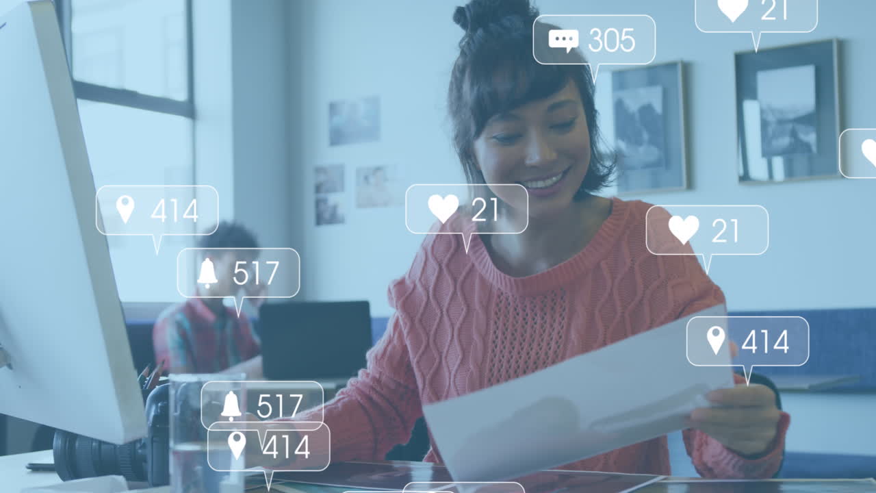Animation of media icons over diverse business people working in office