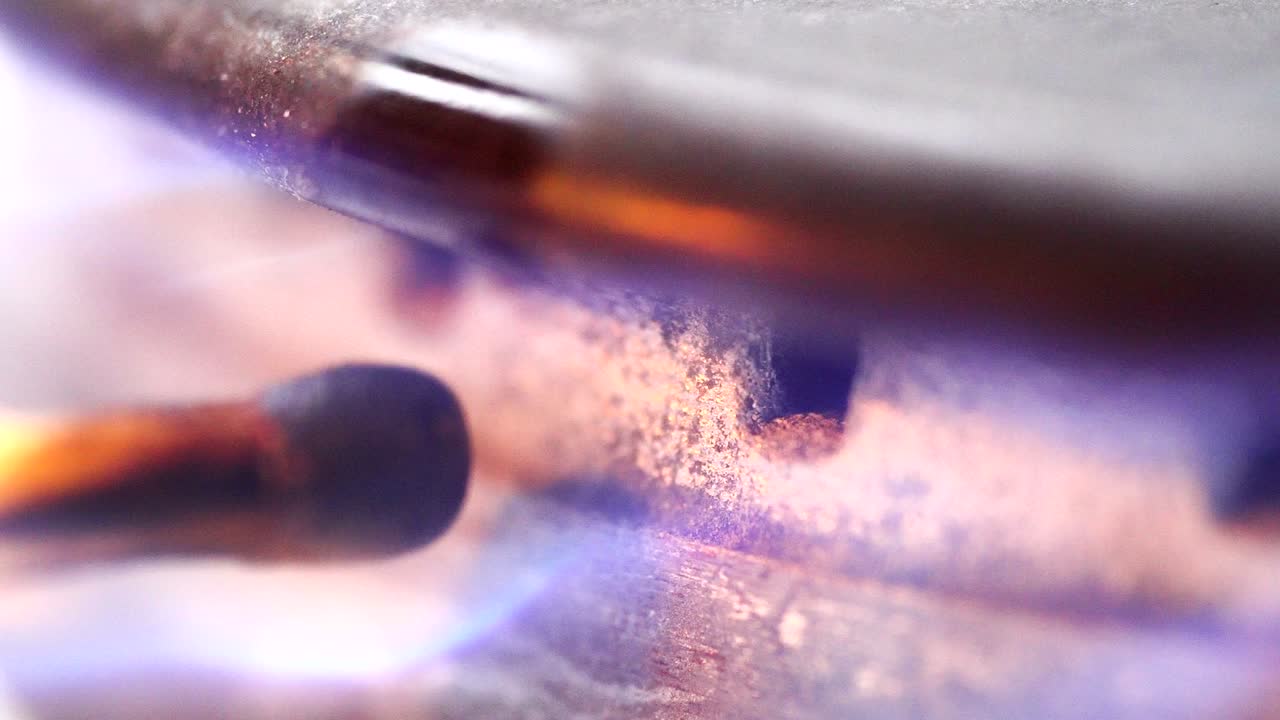 불타는 매치가 가스 스토브 버너 매크로의 노즐에 가스를 점화시니다.