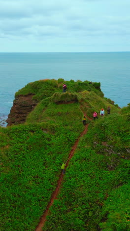 hikers on a coastal cliff trail