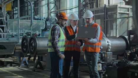 female engineer and male supervisor walking in warehouse aisle discussing logistic task using laptop female engineer and male supervisor walking in warehouse aisle discussing logistic task using laptop in slow motion representing diversity and cooperation in modern work culture