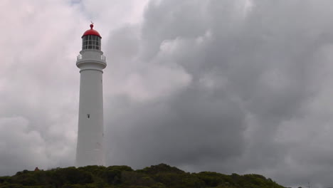 a lighthouse stands among an overcast sky