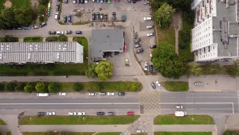 parking lot and rooftop of old apartment building, aerial top down view