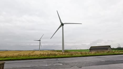wind turbines rotating in a rural landscape