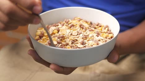 child eating a bowl of cereal for breakfast