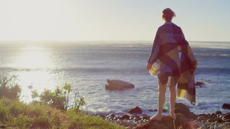 woman standing near seaside on a sunny day 4k