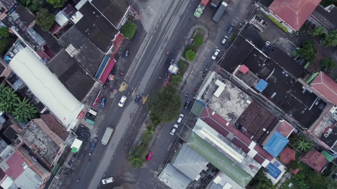 Aerial drone footage of El Placer corregimiento in El Cerrito Valle del Cauca Colombia showing rooftops and main road