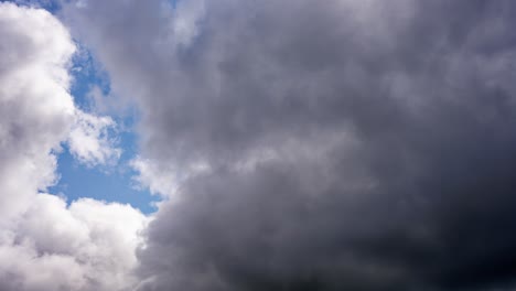 High-speed-cloud-formation-heralding-a-storm,-timelapse-of-large-white-clouds-against-a-blue-sky