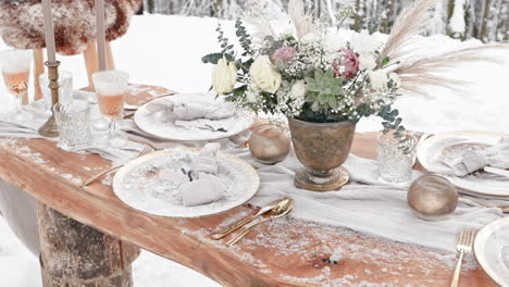 decorated table for luxury wedding arranged outside in snowy winter forest