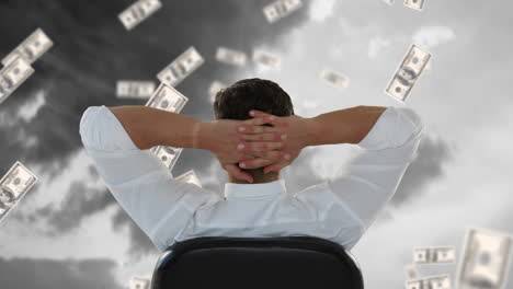 businessman sitting outside while dollars fall down.