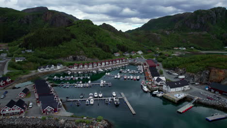 forwarding aerial shot of tonnes harbor with dramatic sky during summer in northern scandinavia