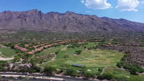 santa catalina mountains with traffic driving along golf course in catalina foothills in tucson, arizona, usa