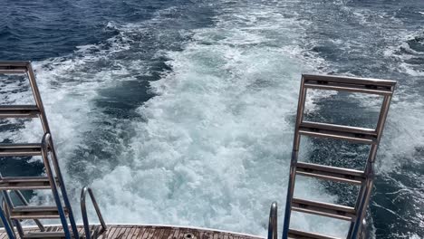 view from boat sailing in the large blue sea near the coastline of the long island in hot weather