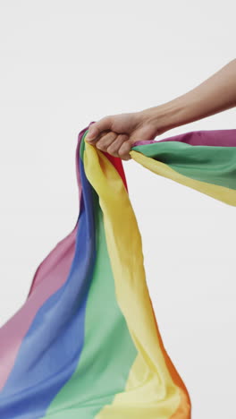 vertical video of hand of caucasian woman holding rainbow fabric