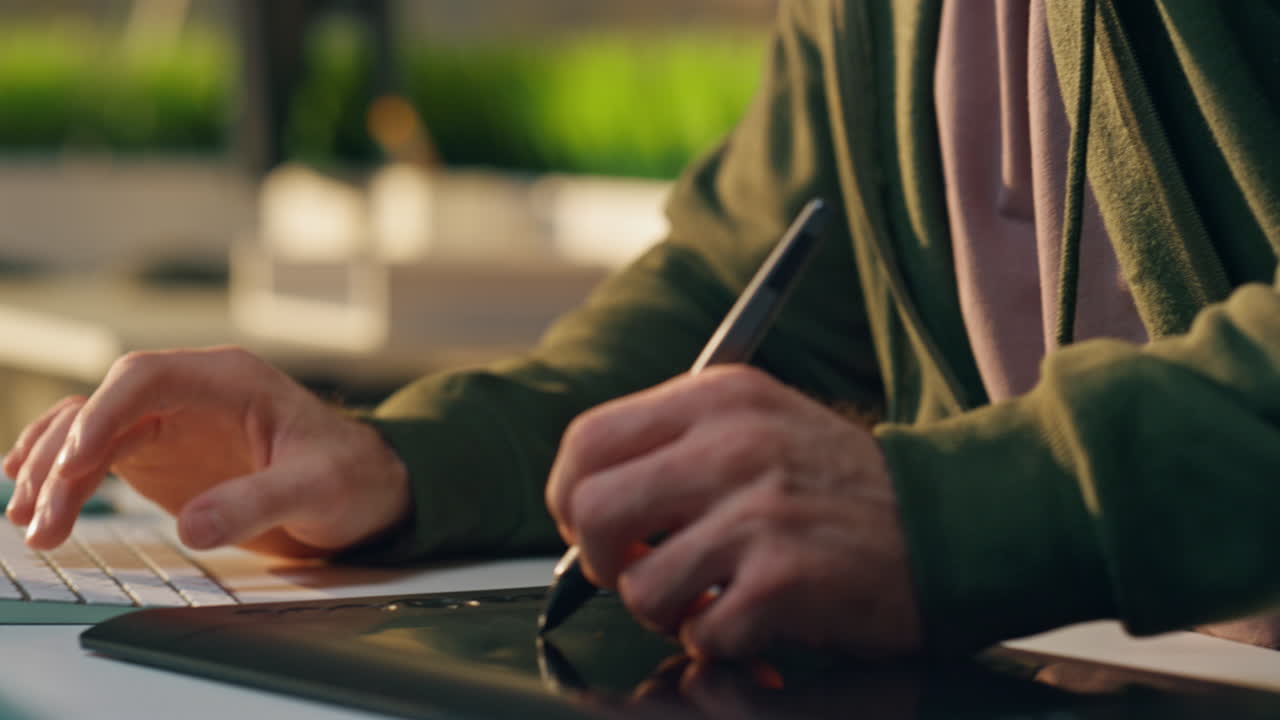 Focused freelancer talk smartphone at workplace closeup. Designer hand drawing