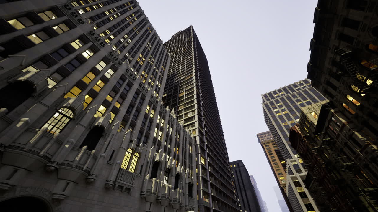 Skyscrapers illuminated at twilight in a bustling urban area