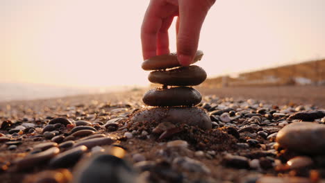 Hand-Puts-Stones-In-The-Pyramid-The-Sun's-Rays-Shine-Through-His-Fingers