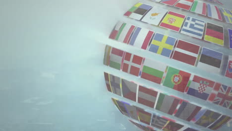 rotating globe with international flags animation over light blue background