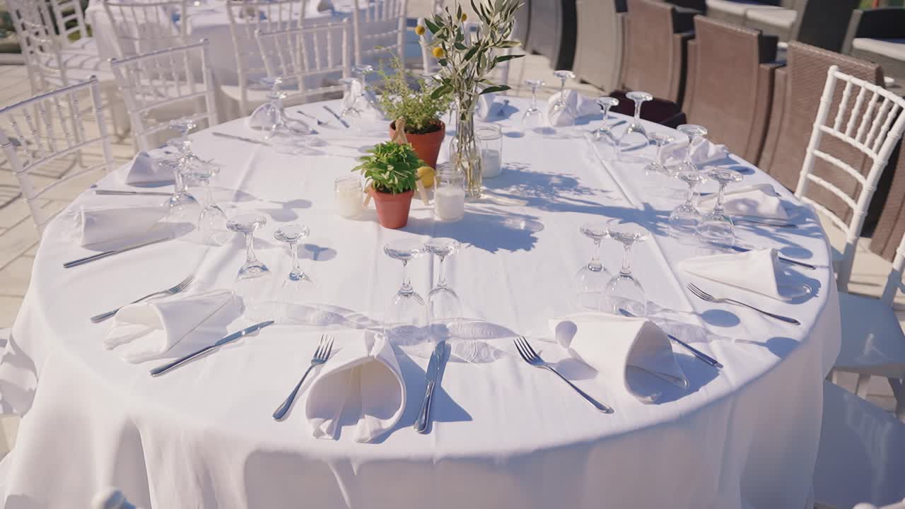 Elegantly set table outdoors for a wedding reception under clear sky