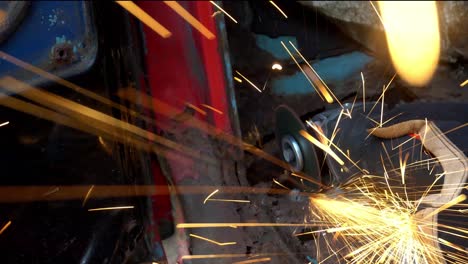 angle grinder on rusty truck metal cutting sparks