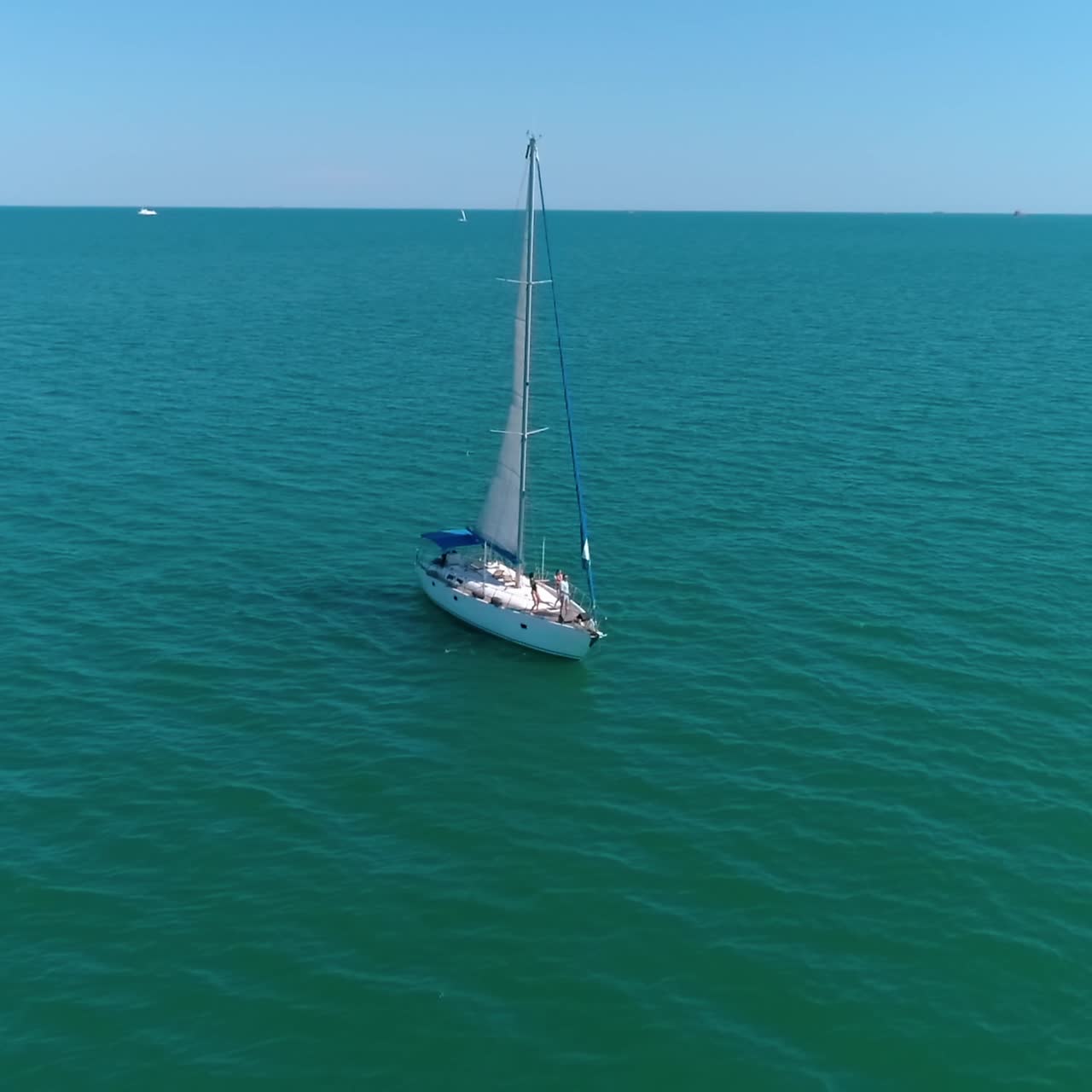 Aerial view of yacht holding at the sea. Young group of people dancing at the yacht