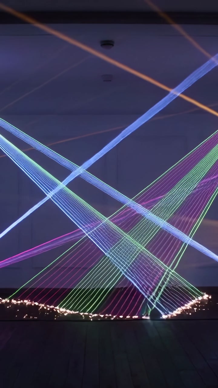 Vertical video: Starting sequence, floor lasers beaming colored lines for stage show, sparks firing