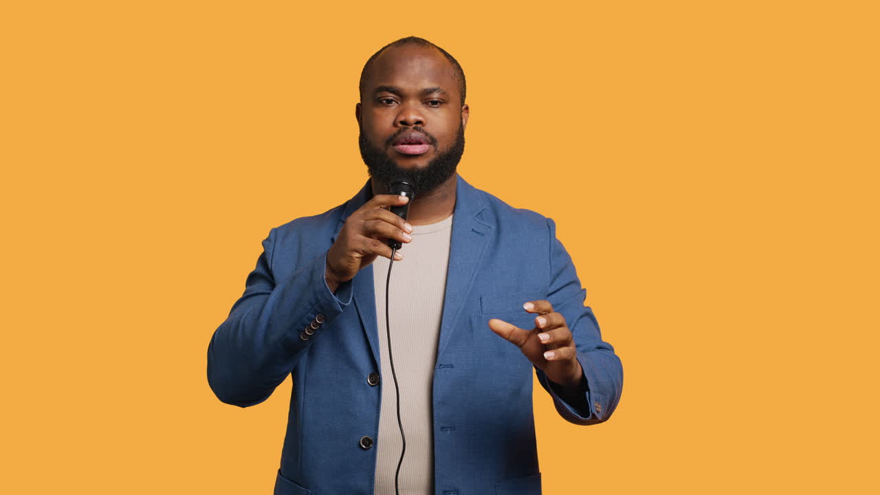 Lecturer holding monologue using microphone, studio background