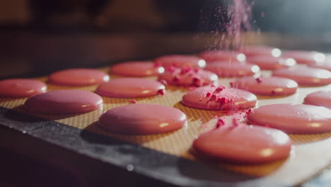 making pink macarons with raspberry topping