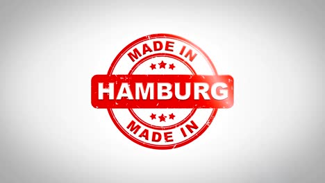 made in hamburg signed stamping text wooden stamp animation. red ink on clean white paper surface background with green matte background included.